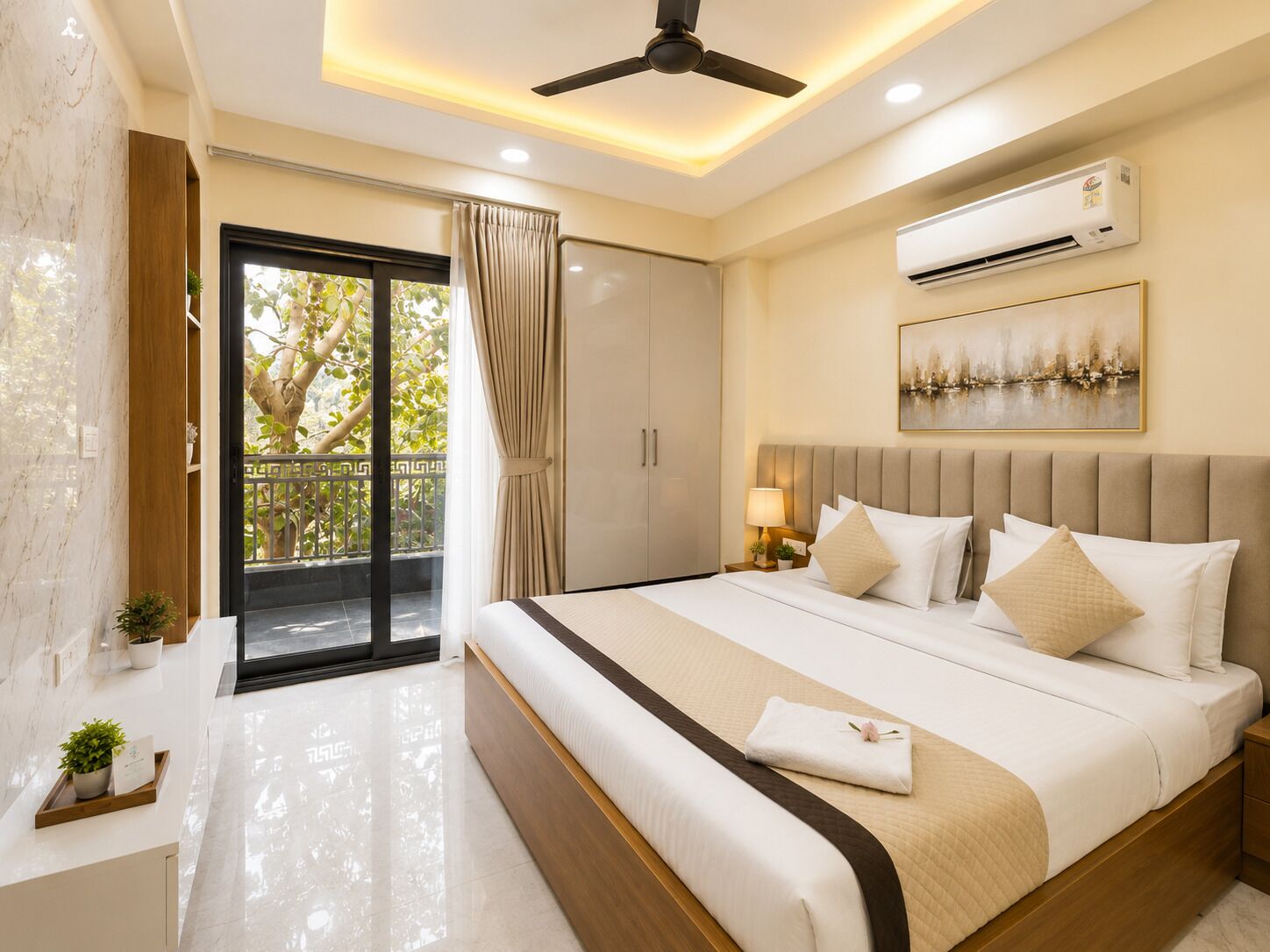 A hotel room with a bed, an air conditioning unit, a ceiling fan, a balcony with curtains, and a painting on the wall.