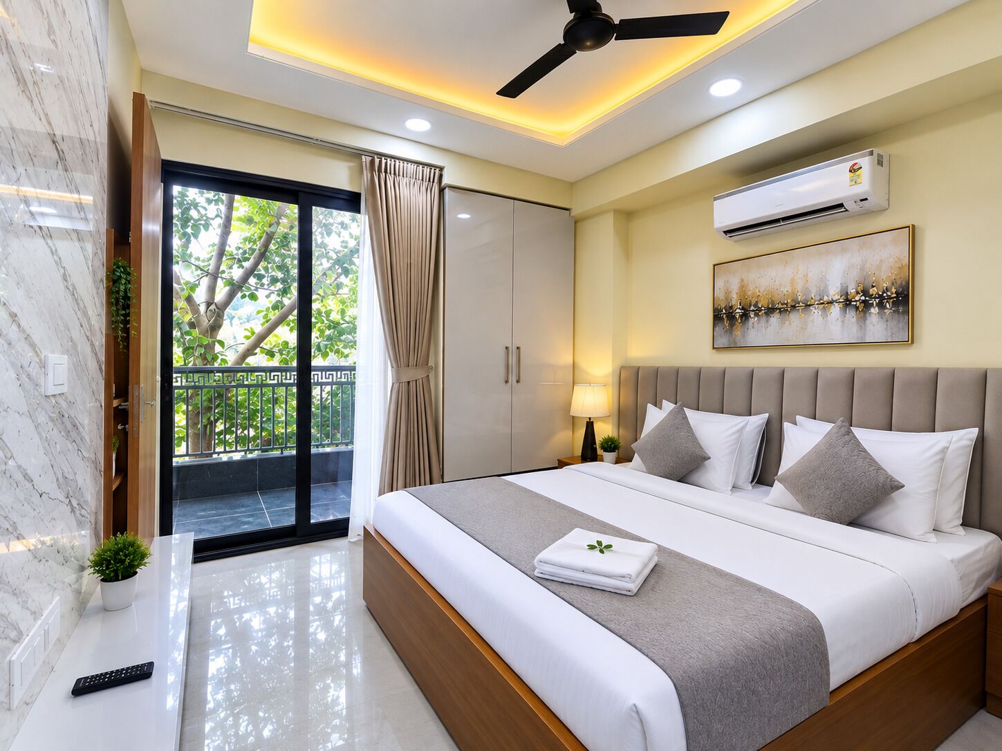 A modern bedroom with a bed, bedside table, and a ceiling fan.