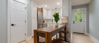 Charming cottage entrance with cozy curb appeal, nestled in a peaceful and green setting.