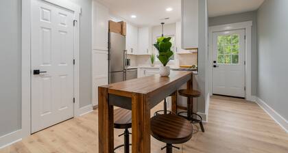 Charming cottage entrance with cozy curb appeal, nestled in a peaceful and green setting.