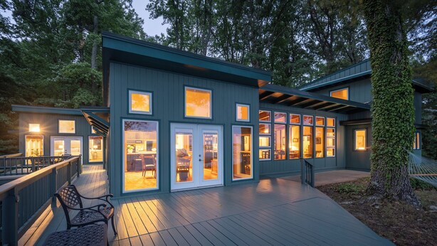 A modern building with a deck, large windows, and a covered outdoor area. - Scenic, Spacious Riverside Retreat | Ropeyarn (Deltaville)