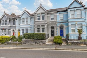 A row of Victorian-style houses with distinct architectural features, including bay windows and decorative trim.