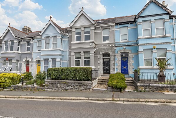 A row of Victorian-style houses with distinct architectural features, including bay windows and decorative trim.
