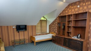 A room with a bed, a TV mounted on the wall, a wooden cabinet, and a patterned carpet. - Qabala Semerena Riverside Hotel (Gabala)