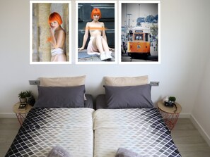 A double bed with patterned bedding, two bedside tables with plants, and a wall-mounted TV. - New luxury complex near the sea (Playa Paraiso)