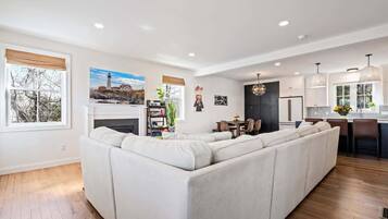House, Multiple Beds, Patio, Garden View (The Coastal Playhouse) | Living area | 42-inch flat-screen TV with digital channels, fireplace