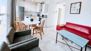 A modern apartment with a kitchen, dining area, and living room.