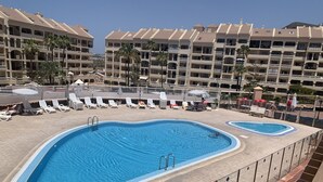 A hotel pool area with multiple pools, sun loungers, and a lifebuoy. - Penthouse in Los Cristianos with Large Pools (Los Cristianos)