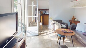 A modern living room with a flat-screen TV, a dining table, and a sofa. - House in Vic-la-Gardiole, 2 pers, Terrace, Close to Beach (Vic-la-Gardiole)