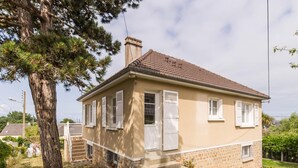 A two-story house with a tiled roof, white shutters, and a stone foundation. - House in St Pair-sur-Mer with Garden and Private Parking, Near the Beach (Saint-Pair-sur-Mer)