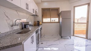 A modern kitchen with granite countertops, a built-in oven, and a refrigerator. - Traditional/Modern Apartment, Full A/C, 10m to Airport, 15m to centre. (Marrakech)