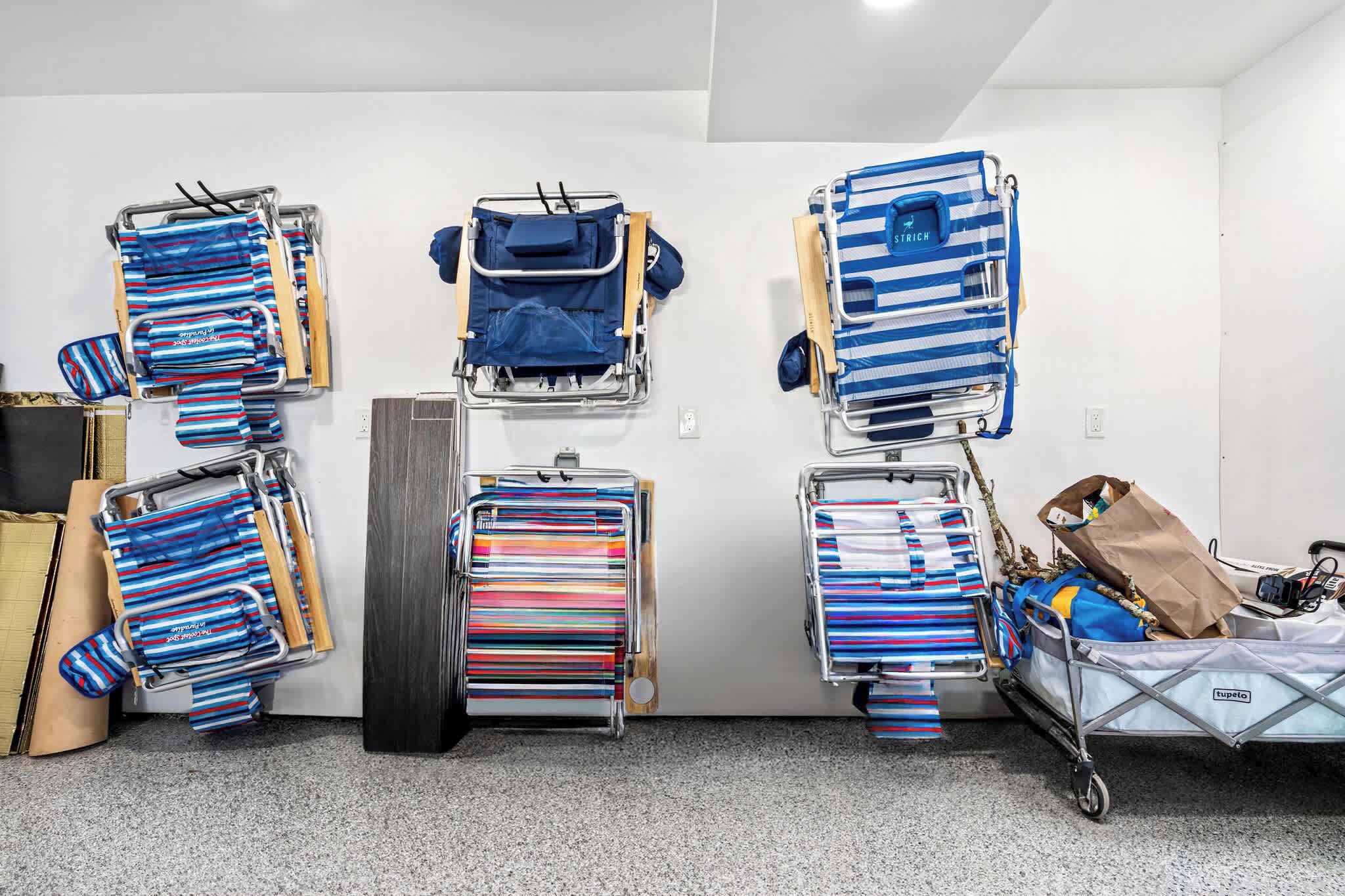 A room with multiple luggage carts and a wall-mounted luggage rack.