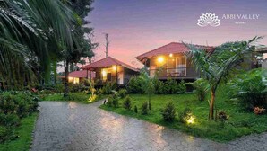 A resort with two buildings, a paved pathway, and well-maintained greenery. - Abbi Valley Resorts  (Sakleshpur)