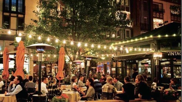 An outdoor dining area with tables and chairs, string lights, and umbrellas. - Santana Row Properties #9 - Silicon Valley Getaway: Escape the Ordinary! (San Jose)