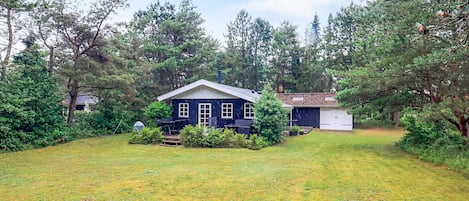 A house with a front yard and a garage.