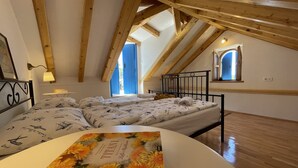 A bedroom with a bed, a bedside table, a lamp, a window, and a book on a table. - Holiday Home Cherry with pool (Vrsine)