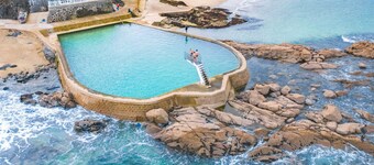 Typical Breton house with garden near the sea and the Bay of Saint Brieuc