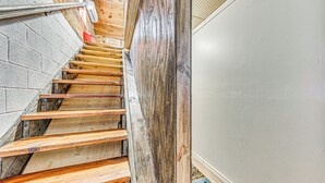 A staircase with wooden steps and a white wall on the right. - < 1 Mi to Grindstone Lake: Cabin w/ Large Yard! (Ruidoso)