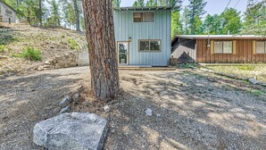 A cabin with a small porch, a wooden deck, and a large tree in the foreground. - < 1 Mi to Grindstone Lake: Cabin w/ Large Yard! (Ruidoso)