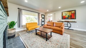 A living room with a sofa, a coffee table, a rug, and a potted plant. - 3 Mi to Dtwn: Family Home w/ Garden & EV Charger (Yakima)