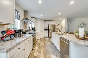 A modern kitchen with white cabinetry, stainless steel appliances, and a granite countertop. - 10 Mi to Echo Lake: Wooded Escape w/ Grill! (Conway)