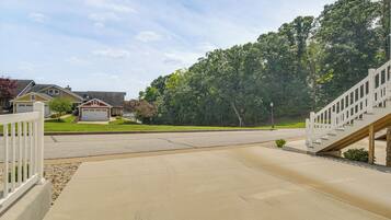 A residential driveway with a concrete path leading to a house with a garage.