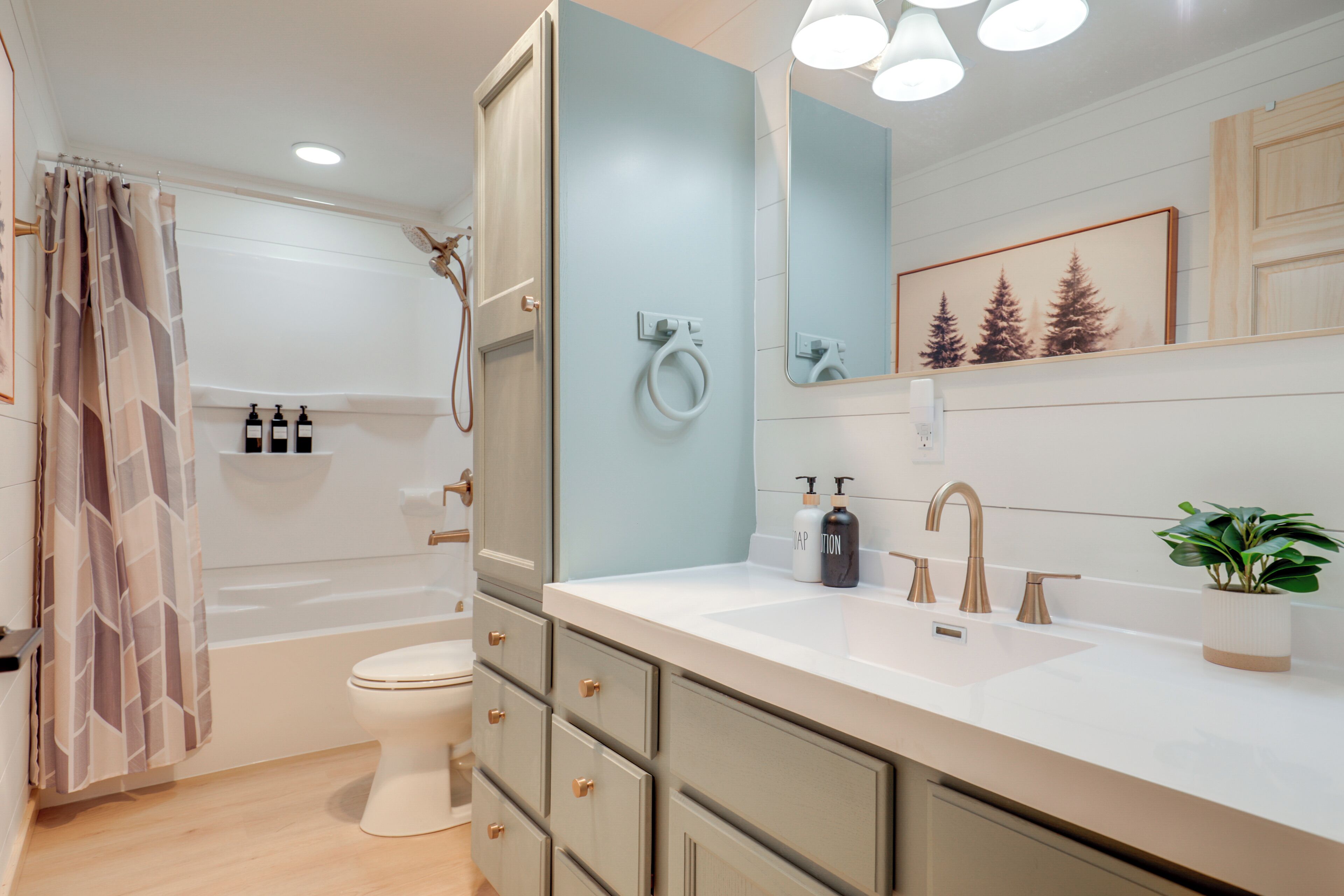 A modern bathroom with a bathtub, toilet, and sink.