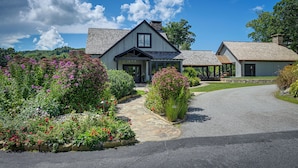 A two-story house with a stone pathway leading to the entrance, surrounded by well-maintained gardens. - Resort Perks, By Lake Glenville: Chinquapin Escape (Glenville)