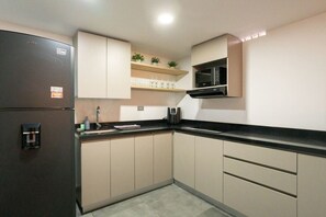 Fridge, microwave, coffee/tea maker, cookware/dishes/utensils