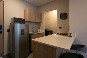 Fridge, microwave, coffee/tea maker, cookware/dishes/utensils