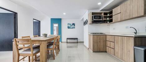 Fridge, microwave, coffee/tea maker, cookware/dishes/utensils