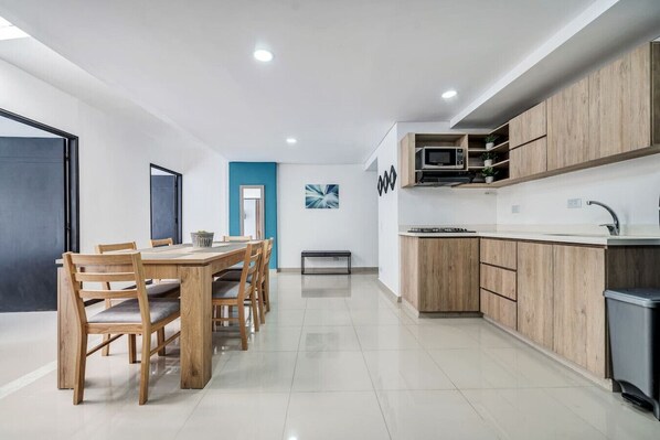 Fridge, microwave, coffee/tea maker, cookware/dishes/utensils