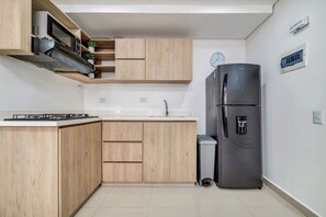 Fridge, microwave, coffee/tea maker, cookware/dishes/utensils