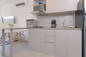 Fridge, microwave, coffee/tea maker, cookware/dishes/utensils