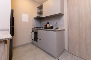 Fridge, microwave, coffee/tea maker, cookware/dishes/utensils