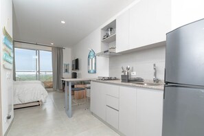 Fridge, microwave, coffee/tea maker, cookware/dishes/utensils