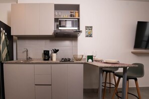 Fridge, microwave, coffee/tea maker, cookware/dishes/utensils