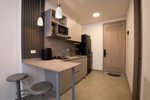 Fridge, microwave, coffee/tea maker, cookware/dishes/utensils