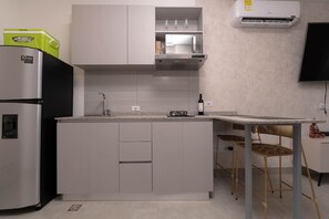 Fridge, microwave, coffee/tea maker, cookware/dishes/utensils