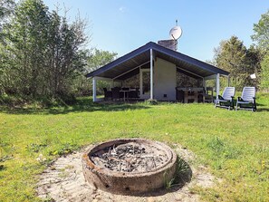 A covered outdoor area with a fire pit, a satellite dish, and two chairs. - 6 Person Holiday Home in Jerup (Jerup)