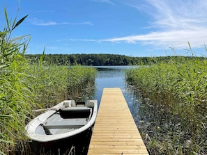 A wooden dock leading to a small boat. - 4 Star Holiday Home in Sollentuna (Sollentuna)