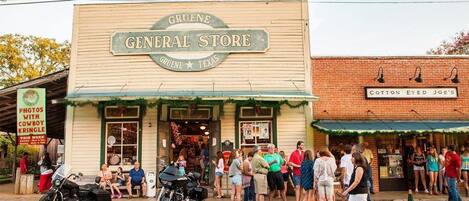 A storefront with a sign reading "Gruene General Store" and "Cotton Eyed Joe's" in Gruene, Texas.