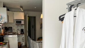 A compact kitchen with a microwave, coffee maker, and a small dining area. - 4 Star Holiday Home in Laholm (Skummesloevsstrand)
