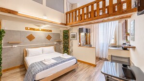 A modern bedroom with a wooden bed, a desk, and a balcony.