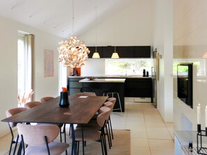 A modern kitchen with a dining area. - 5 Star Holiday Home in Blokhus (Blokhus)