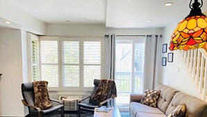 A living room with two chairs, a sofa, a coffee table, and a hanging lamp. - Blue Mountain Suites (Blue Mountain)