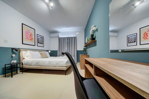 2 habitaciones, escritorio y tabla de planchar con plancha