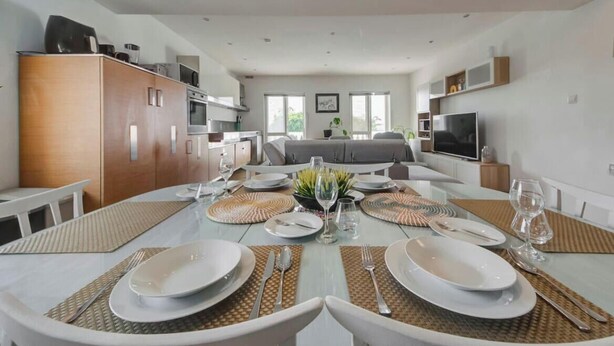 A modern kitchen with a dining area set for six. - Elegant & cosy 3BR home in peaceful area of Naxxar (In-Naxxar)