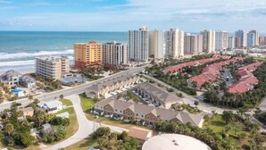 A coastal residential area with high-rise buildings, a marina, and a large hotel with a central courtyard. - 6 Bedrooms - OCEAN VIEW, 2 Game Rooms, Parking, AC (Daytona Beach Shores)