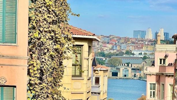 A view of a river with buildings on the opposite bank. -  The Wooden 17 (Istanbul)